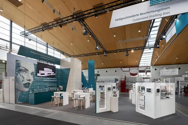 Hauptbereich des Venjakob-Stands mit großem LED-Wandmotiv und maßgefertigten Präsentationstischen.